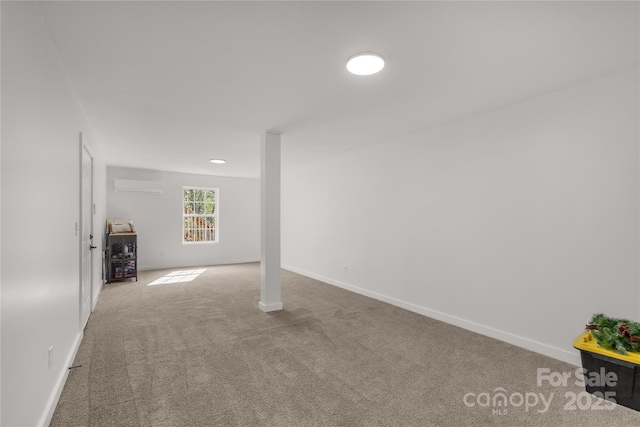 below grade area featuring baseboards, an AC wall unit, and carpet flooring