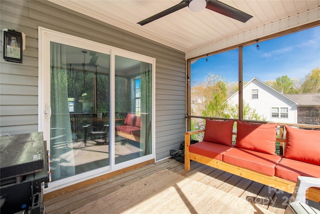 sunroom featuring a ceiling fan and an outdoor hangout area