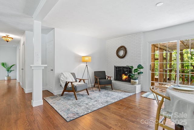 9 Mikayla Ln, Candler, NC 28715 - living area with a brick fireplace, wood finished floors, and baseboards