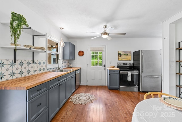 9 Mikayla Ln, Candler, NC 28715 - kitchen with stainless steel appliances, a sink, butcher block countertops, open shelves, and gray cabinetry
