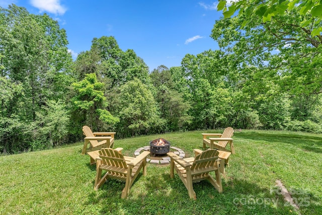 9 Mikayla Ln, Candler, NC 28715 - view of grassy yard with a fire pit and a view of trees