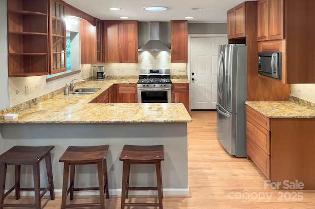 80 Vance Gap Rd, Asheville, NC 28805 - kitchen featuring a sink, wall chimney exhaust hood, tasteful backsplash, appliances with stainless steel finishes, and a peninsula