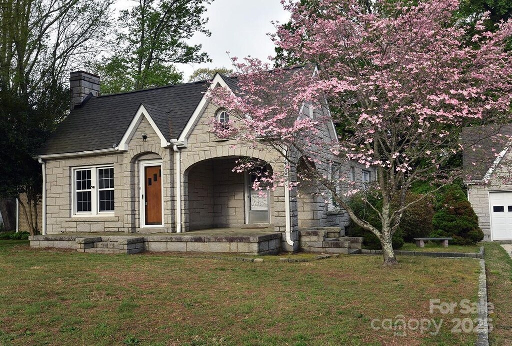 1460 Legion Club Rd, Salisbury, NC 28146 - view of front facade featuring stone siding, a chimney, a shingled roof, and a front yard