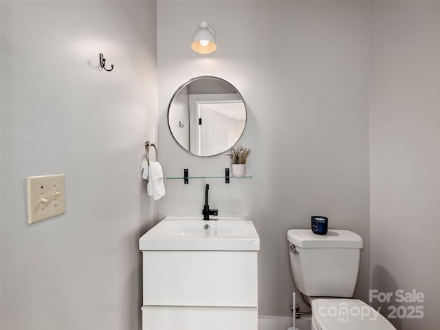 half bathroom featuring toilet and vanity