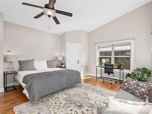 bedroom with vaulted ceiling, baseboards, visible vents, a ceiling fan, and wood finished floors