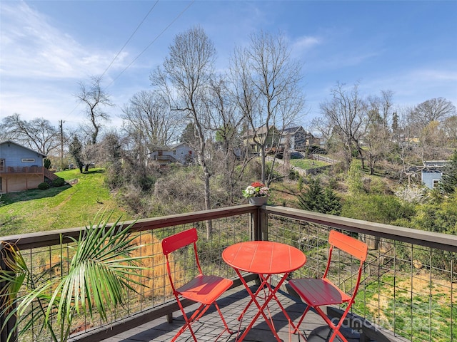 wooden terrace featuring a yard