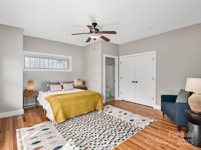 bedroom with a closet, baseboards, ceiling fan, and wood finished floors