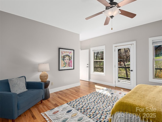 bedroom with baseboards, a ceiling fan, wood finished floors, and access to outside