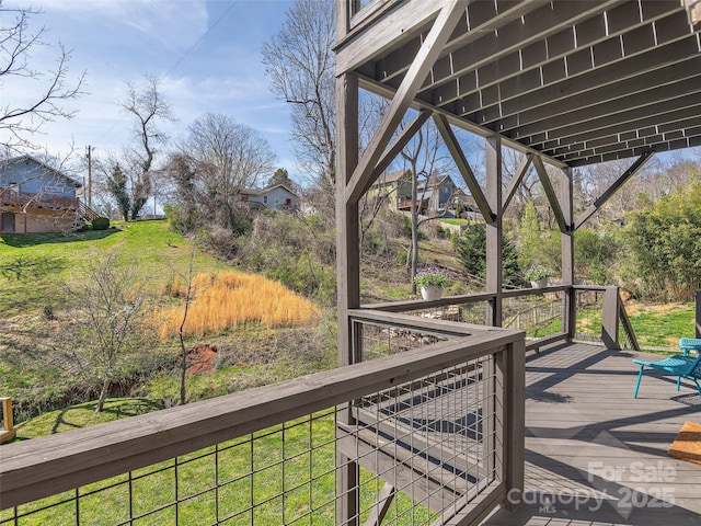 wooden terrace with a lawn