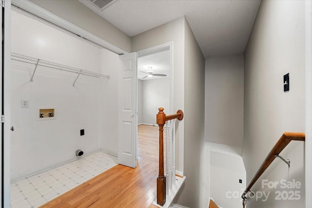 laundry area with laundry area, light wood-style flooring, electric dryer hookup, washer hookup, and ceiling fan