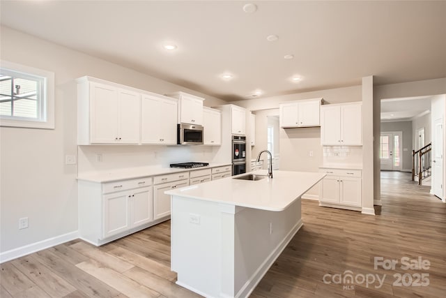 7005 New Town Rd, Waxhaw, NC 28173 - kitchen featuring stainless steel appliances, a sink, white cabinets, and recessed lighting