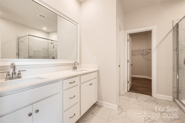 7005 New Town Rd, Waxhaw, NC 28173 - bathroom featuring marble look tiles, baseboards, a shower stall, and double vanity