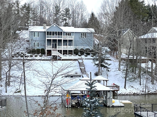 56 Lake Mist Ct Unit 30 & 30A, Nebo, NC 28761 - snow covered back of property featuring a water view, stairs, a balcony, and a chimney