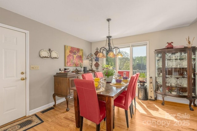 56 Lake Mist Ct Unit 30 & 30A, Nebo, NC 28761 - dining space with visible vents, baseboards, a chandelier, and light wood-style floors