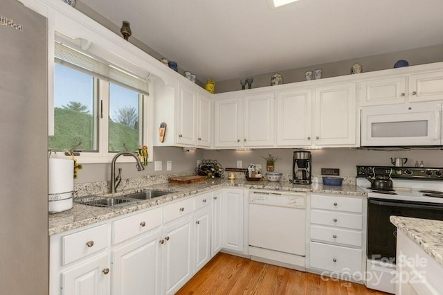 56 Lake Mist Ct Unit 30 & 30A, Nebo, NC 28761 - kitchen featuring white appliances, white cabinetry, light stone counters, a sink, and light wood finished floors