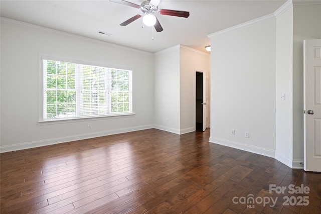 spare room with visible vents, dark wood-type flooring, crown molding, baseboards, and ceiling fan