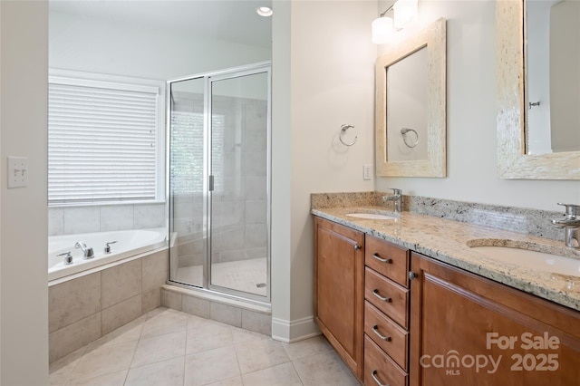 bathroom with a shower stall, tile patterned flooring, and a sink