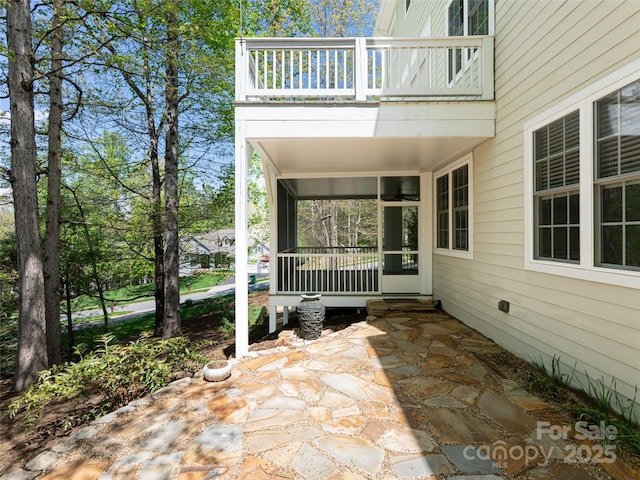 view of patio featuring a balcony