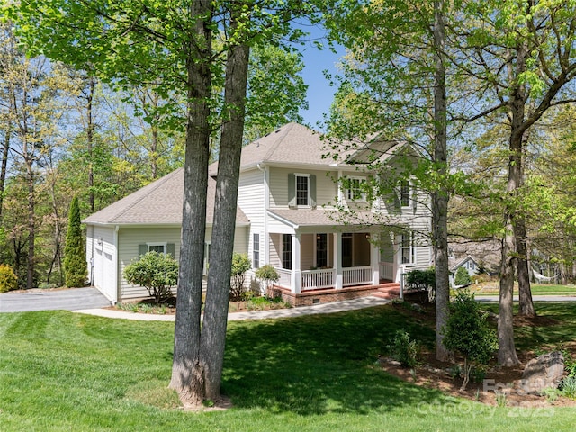 colonial home featuring aphalt driveway, a shingled roof, a front lawn, and covered porch