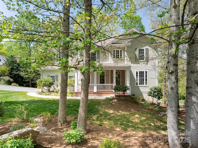 view of front of home featuring a porch and a front lawn
