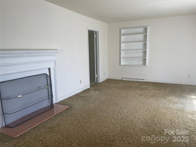 unfurnished living room with built in features, a baseboard heating unit, baseboards, and carpet