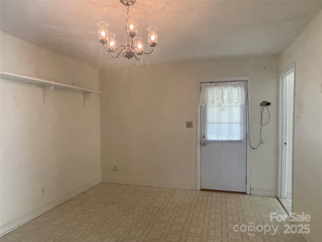 unfurnished dining area featuring tile patterned floors and a notable chandelier