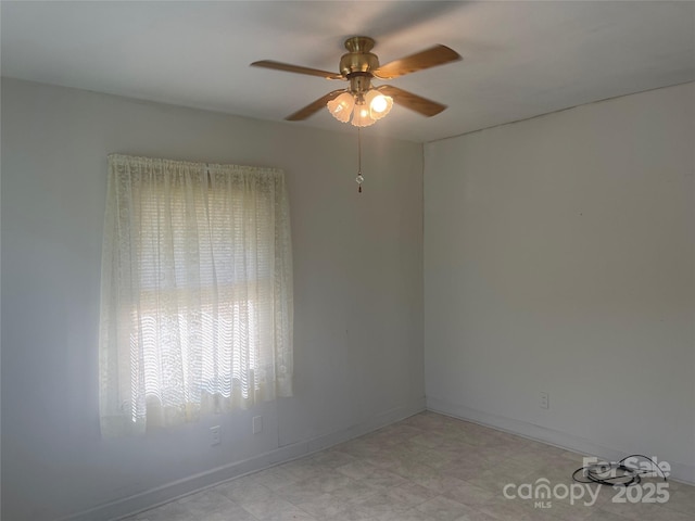 unfurnished room featuring baseboards and a ceiling fan