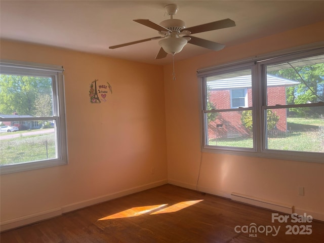 unfurnished room with baseboards, a ceiling fan, a baseboard heating unit, and wood finished floors