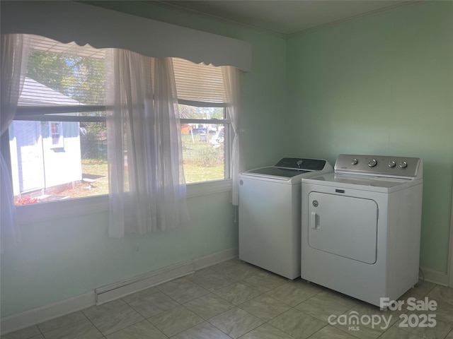 laundry area with laundry area, crown molding, light tile patterned flooring, washer and dryer, and baseboards