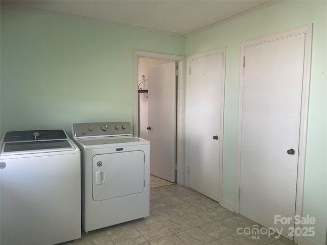 laundry area featuring washer and dryer, laundry area, and ornamental molding