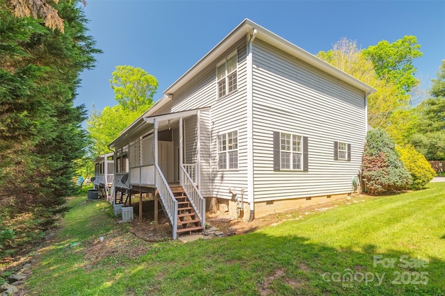 rear view of property with a yard and crawl space