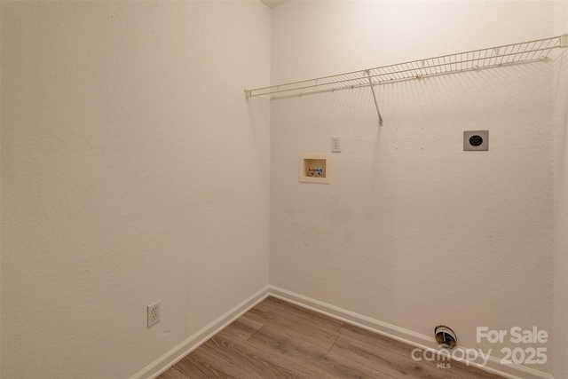 clothes washing area with laundry area, wood finished floors, baseboards, electric dryer hookup, and washer hookup