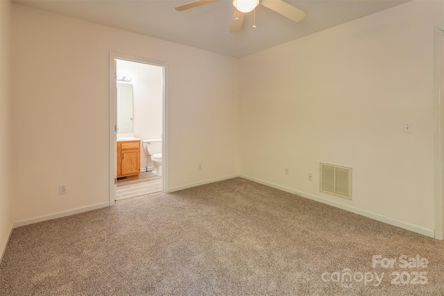 unfurnished room with a ceiling fan, baseboards, visible vents, and light carpet