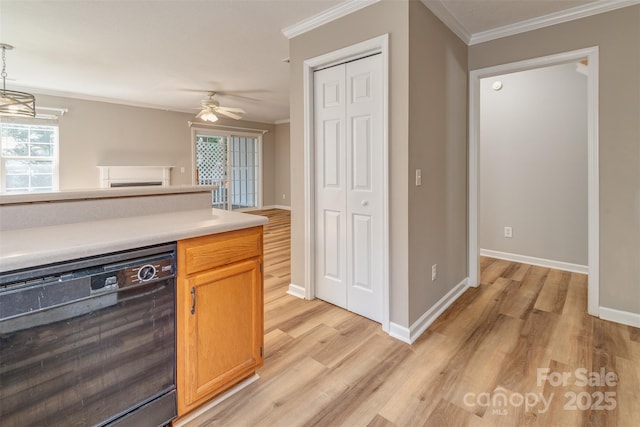 kitchen featuring crown molding, light countertops, light wood finished floors, and dishwasher