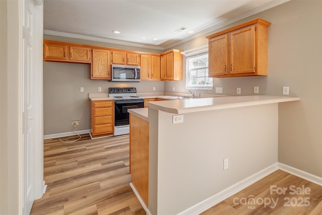kitchen featuring light countertops, stainless steel microwave, a peninsula, electric stove, and ornamental molding