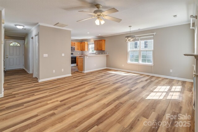 unfurnished living room with crown molding, a ceiling fan, and visible vents