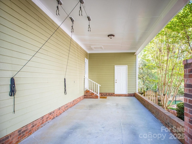 view of patio / terrace featuring entry steps and fence