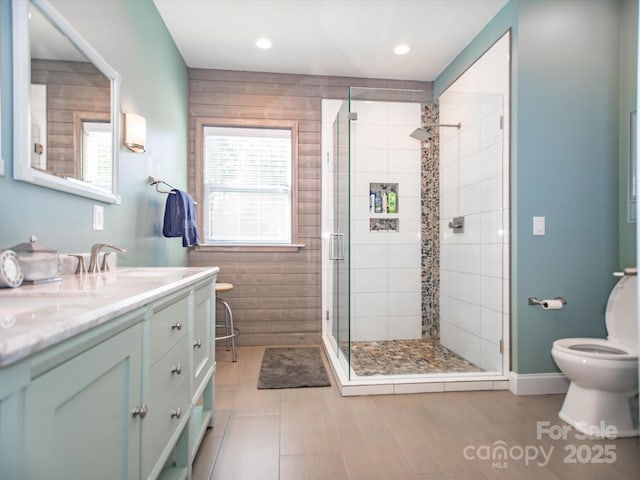 full bathroom with toilet, a stall shower, vanity, and recessed lighting