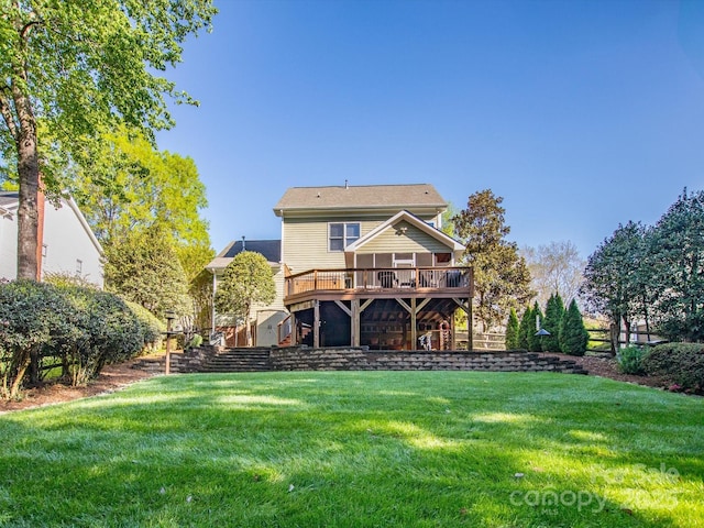 back of house featuring stairway, a yard, and a deck
