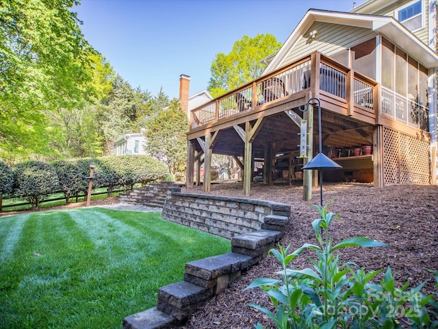 view of yard with a sunroom and a wooden deck