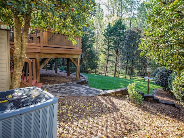 view of yard featuring stairs, central air condition unit, a wooden deck, and fence