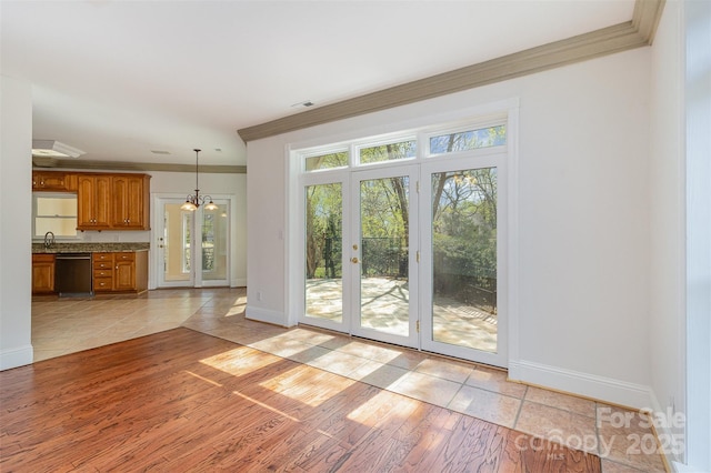 7900 Gilead Rd, Huntersville, NC 28078 - entryway featuring ornamental molding, a sink, baseboards, light tile patterned floors, and french doors
