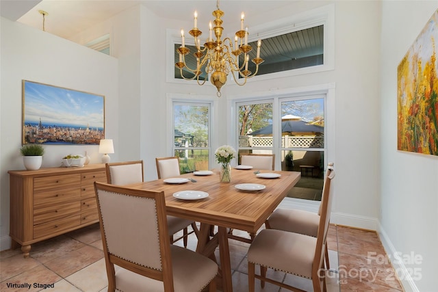 7900 Gilead Rd, Huntersville, NC 28078 - dining space with a chandelier, baseboards, a towering ceiling, and light tile patterned floors