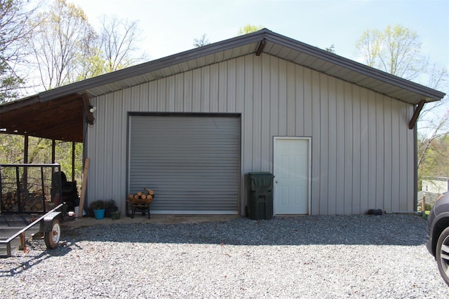 detached garage with gravel driveway