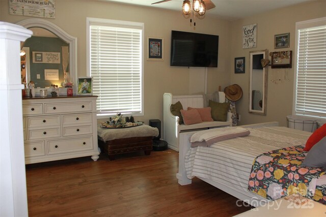 bedroom with ceiling fan and dark wood finished floors