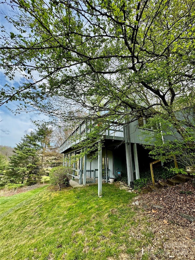 view of side of home with a lawn