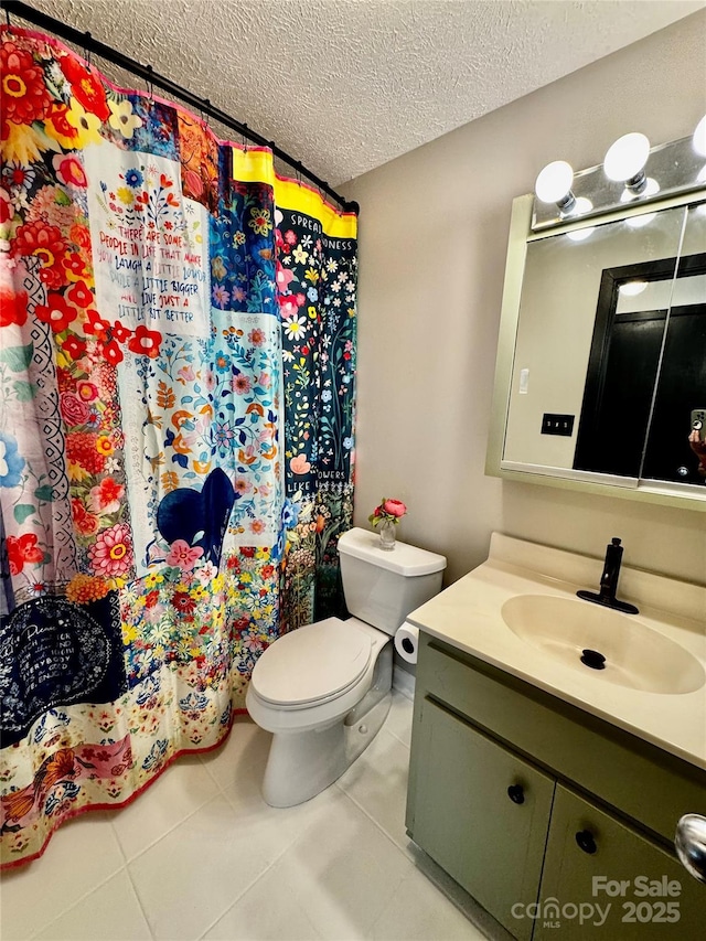 bathroom with a shower with curtain, vanity, tile patterned floors, toilet, and a textured ceiling