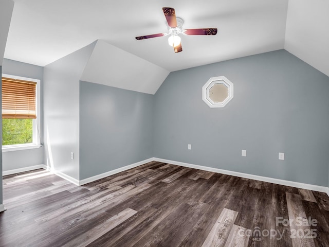 additional living space featuring lofted ceiling, baseboards, a ceiling fan, and wood finished floors