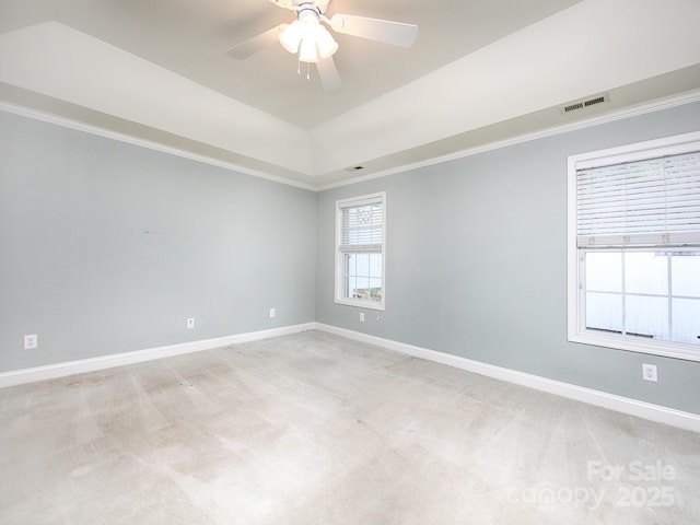 spare room featuring visible vents, light colored carpet, and baseboards