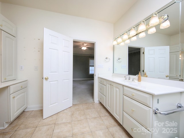 bathroom with baseboards, ceiling fan, tile patterned flooring, and vanity